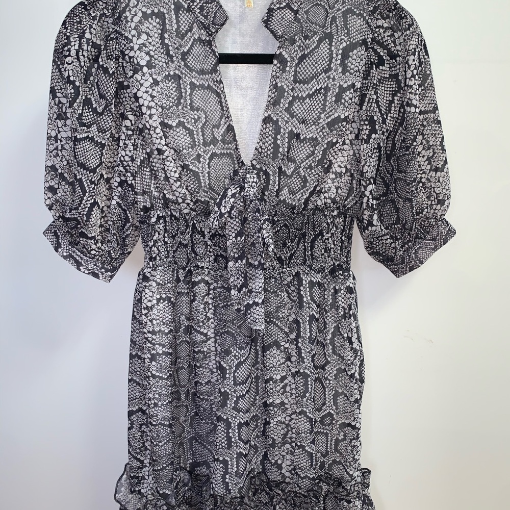 Snake Print dress with ruffle details on the bottom and stretchy belt/waist.